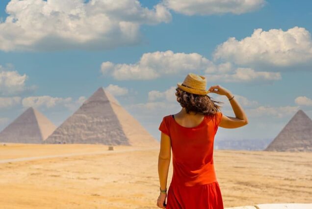 young tourist red dress looking pyramids